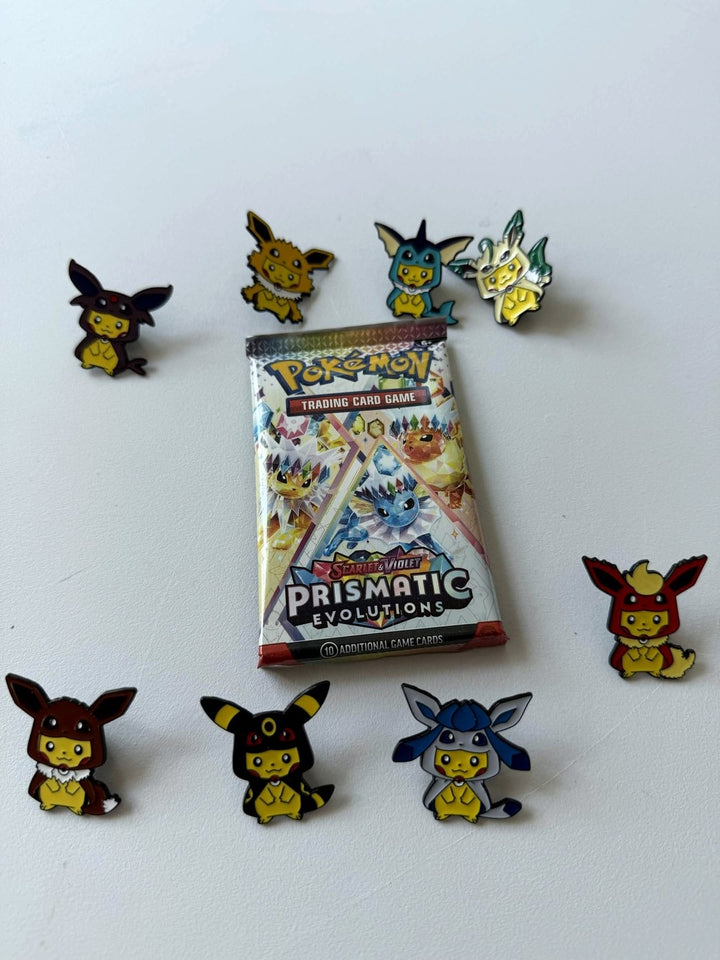 Pokémon trading card game pack with character pins on a white background
